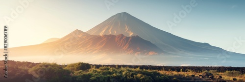 A stunning landscape of a majestic volcano with soft light during sunrise or sunset