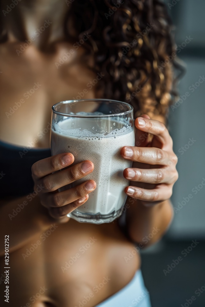 close-up of a girl athlete holding a protein shake. Selective focus close-up of a girl athlete holding a protein shake. Selective focus