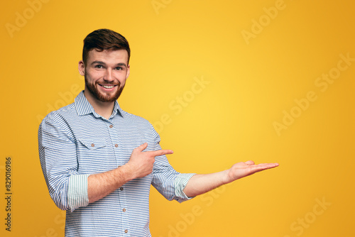 A man extending his hands outward in a gesture of offering or reaching out, holding them up with palms facing forward, copy space