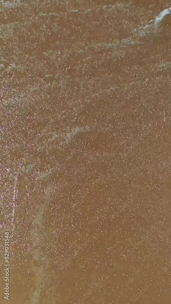 sand and water beach background, top view, copy space, vacation theme, vertical sand and water beach background, top view, copy space, vacation theme, vertical