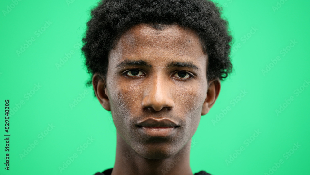 Man's face, close-up, on a green background