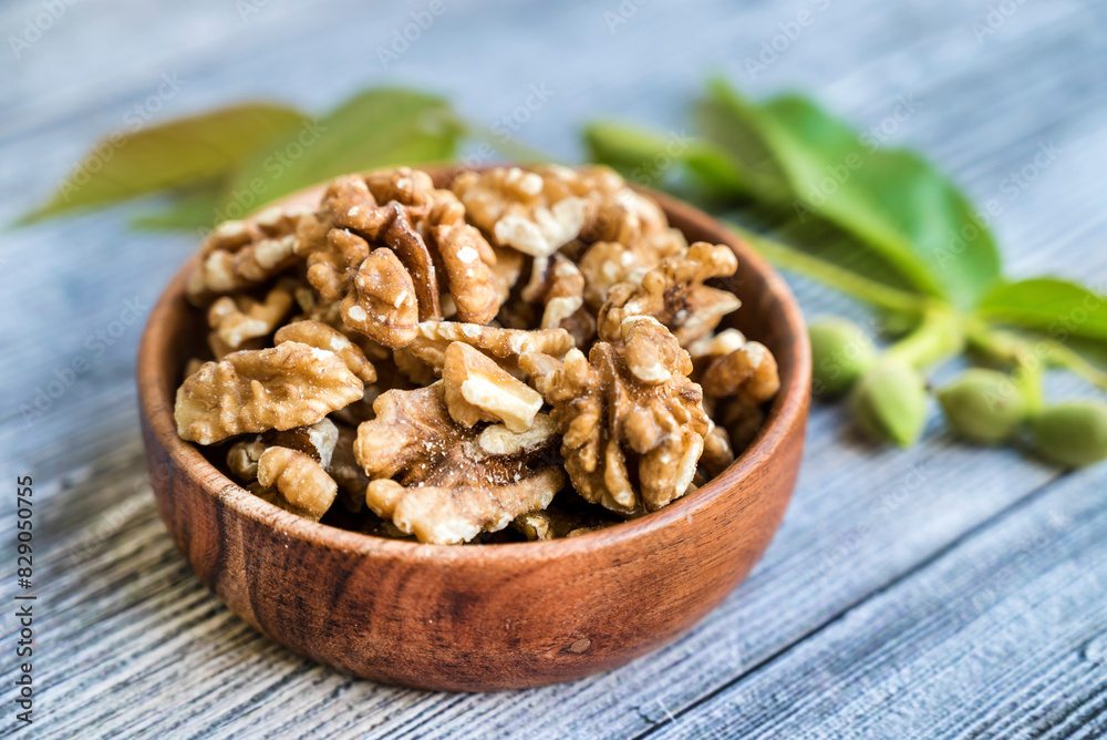 Raw Walnuts in a wooden bowl Raw Walnuts in a wooden bowl