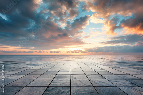 Empty square floor and coastline with sky clouds at sunrise