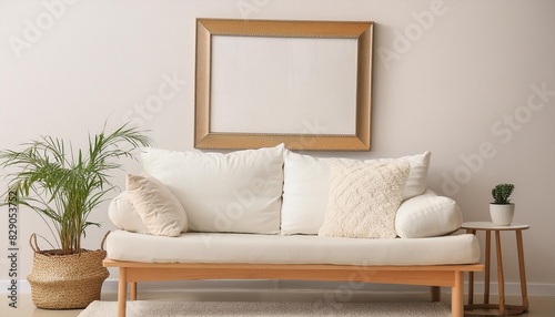 a white couch and a picture frame on a wall