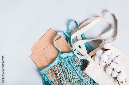 Refusal of plastic bags, string bag, textile bag, paper bags and cotton branch on blue