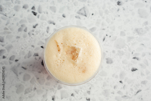 A top down view of a shaken iced tea drink.