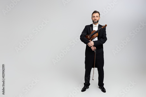 Elegant man violinist on stage at concert