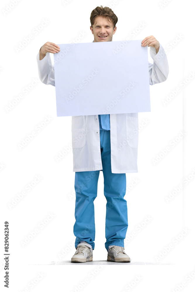 The doctor, in full height, on a white background, shows a white sheet