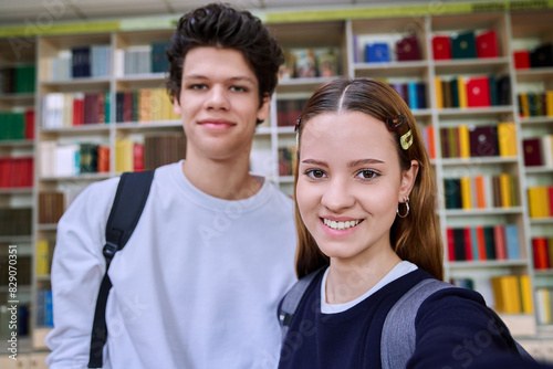 Selfie portrait of friends teenagers high school students looking at camera inside classroom