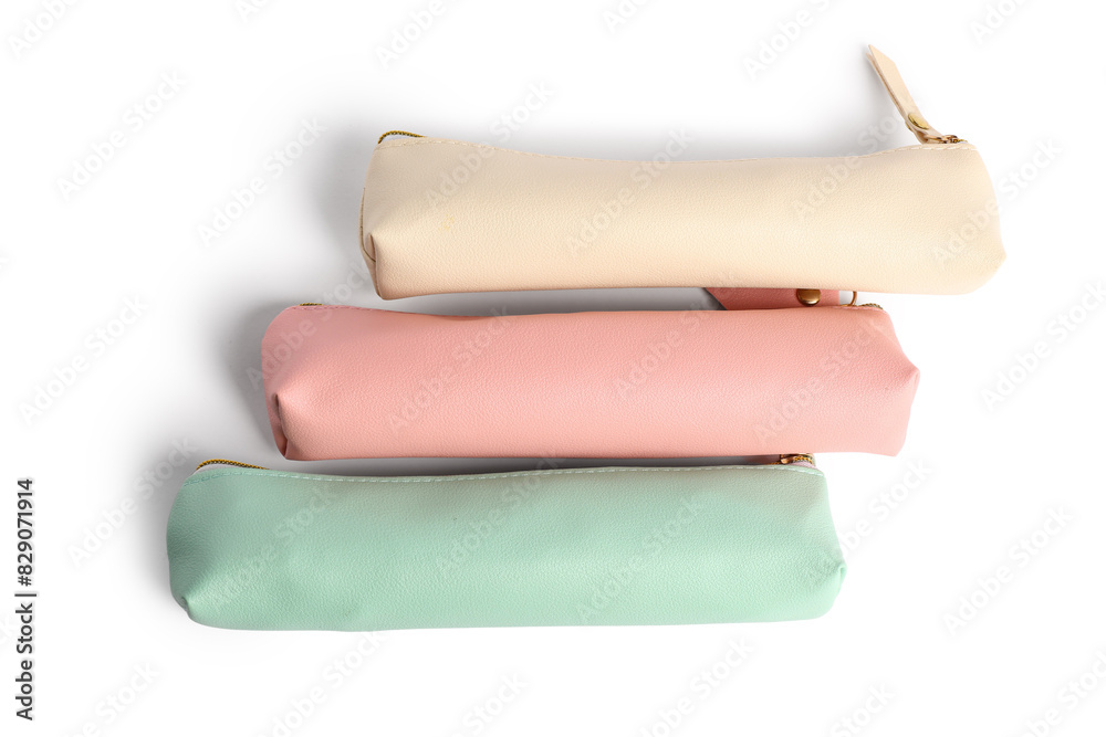Obraz premium Three pastel pencil cases with zippers, school supplies and office organization, isolated on white background