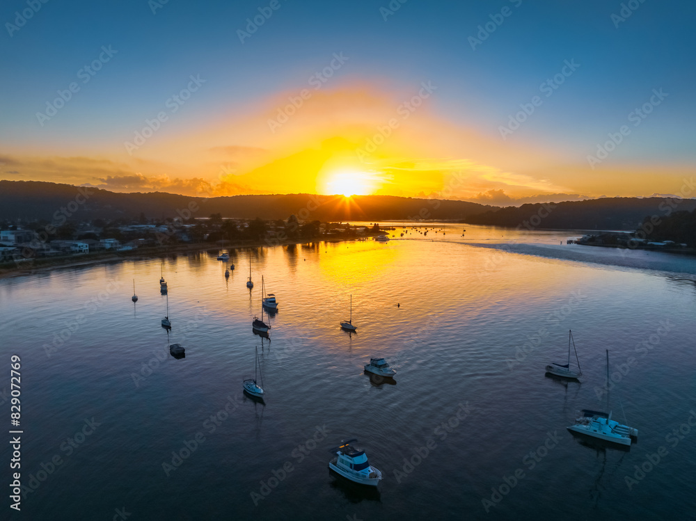 Fototapeta premium A fresh new day - sunrise waterscape with boats in the channel