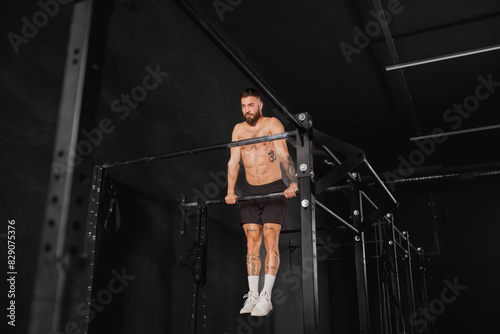 Man performing pull ups on bars, challenging bodyweight exercise. Bodyweight workout for physical and mental health.