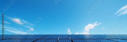 Solar energy concept with photovoltaic cells installed under a blue sky with streaky clouds, sustainable power generation