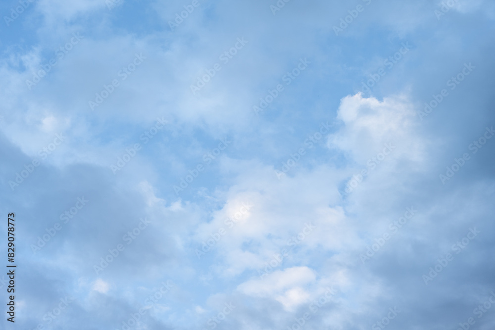 Fototapeta premium Clean blue and white sky nature background, medium blue sky with painterly white and blue clouds