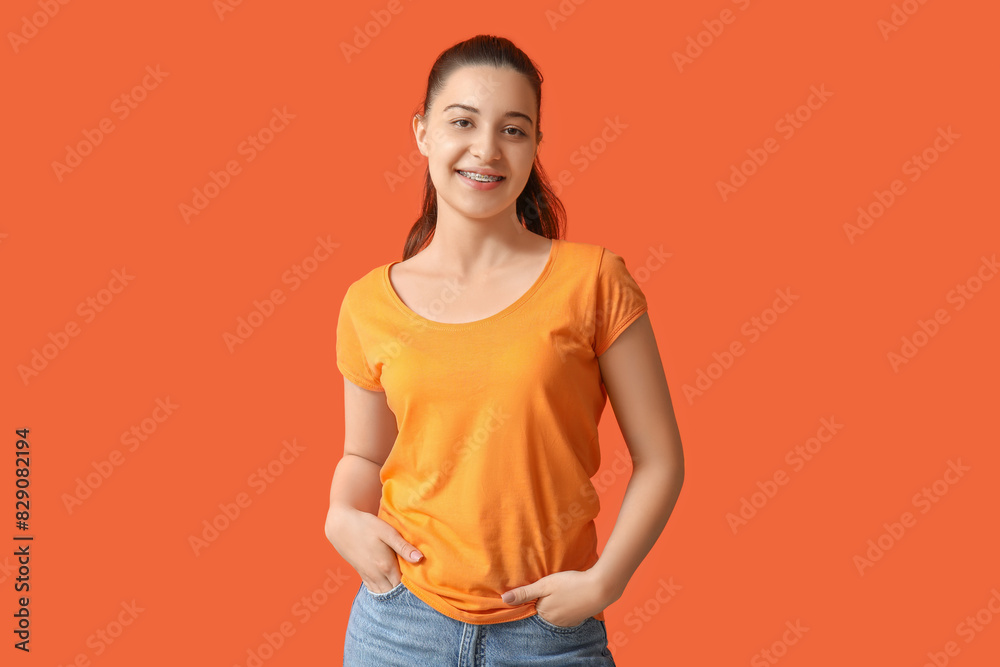 Young woman in stylish orange t-shirt on color background Young woman in stylish orange t-shirt on color background