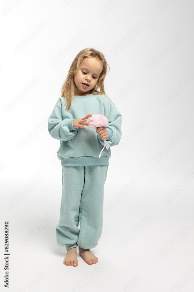 Portrait of beautiful cute little toddler girl. Child with funny face in mint sweatshirt. Pretty smile kid in studio on white background. High quality photo Portrait of beautiful cute little toddler girl. Child with funny face in mint sweatshirt. Pretty smile kid in studio on white background. High quality photo