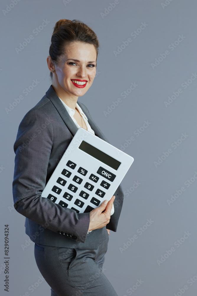 smiling 40 years old business woman against grey smiling 40 years old business woman against grey