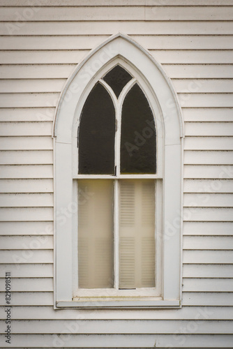 Close-up of an arched Church window with closed internal shutters, USA photo