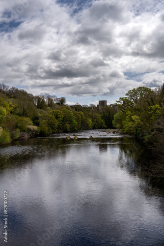 View of Barnard Castle from the river Tees on a cloudy spring day, County Durham, England