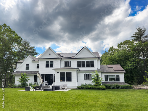 Suburban home with rooftop solar panels sees slow solar production on a cloudy late Spring afternoon