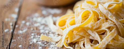 Freshly made tagliatelle pasta on a wooden table