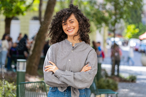 Portrait of happy Caucasian young woman smiling friendly, glad expression looking at camera, resting, relaxation feel satisfied of good news outdoors. Lady girl on urban city street. Town lifestyles