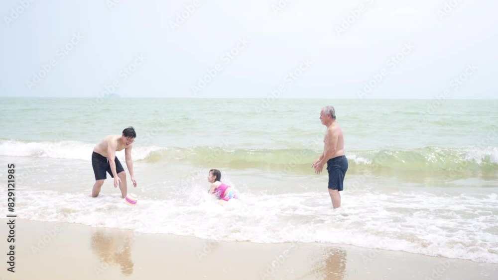 Happy Asian Multi-Generation family enjoy and fun outdoor lifestyle travel ocean on summer holiday vacation. Father, grandfather and child girl kid playing in the sea together at tropical island beach Happy Asian Multi-Generation family enjoy and fun outdoor lifestyle travel ocean on summer holiday vacation. Father, grandfather and child girl kid playing in the sea together at tropical island beach