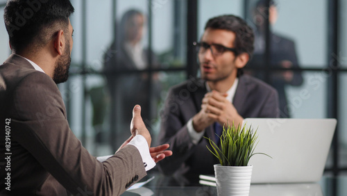 Photos Colleagues chatting, sitting together at office table