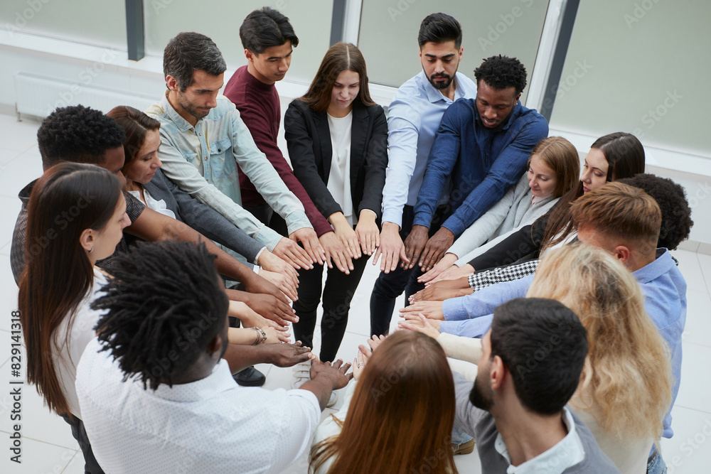 Obraz premium Narrow banner of multiracial people stack hands motivated for shared business success or goal achievement.