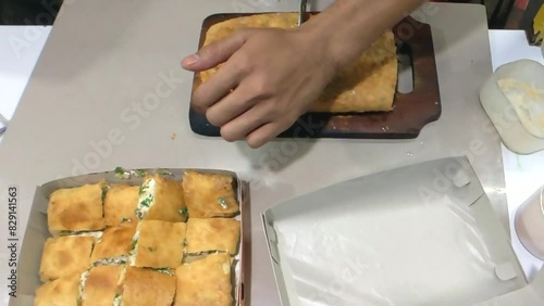 Cinematic shot. The packing process of savory pan-fried pastry famously known as Martabak Telor stuffed with eggs, meat, and onion leaf. One of the well known Indonesian Culinary Cuisine photo