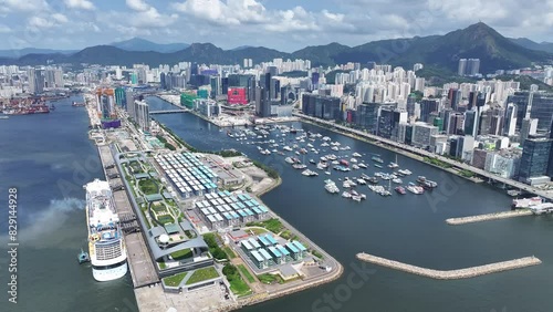 Drone Aerial Skyview of a Mega Luxury Cruise Ship is docking at the Kai Tak cruise terminal near Kai Tak Sports Park Kwun Tong Kowloon Victoria Harbour Hong Kong photo