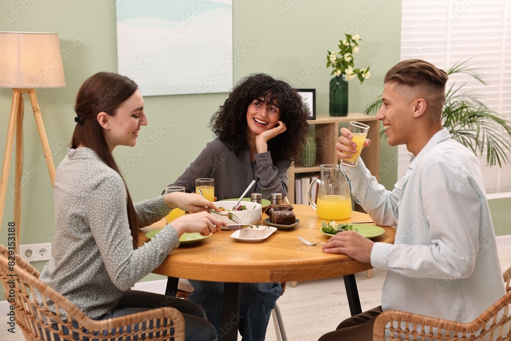 Happy friends having vegetarian meal in cafe Happy friends having vegetarian meal in cafe