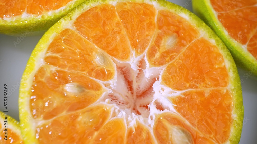 Vivid imagery bursts forth from sliced green-skinned oranges, their juicy segments gleaming against the vibrant contrast of green rind and orange pulp. Orange fruit background.
Vivid imagery bursts forth from sliced green-skinned oranges, their juicy segments gleaming against the vibrant contrast of green rind and orange pulp. Orange fruit background.