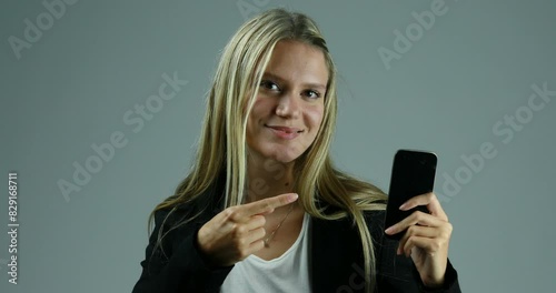 Listens seriously, then demonstrates smartphone possibility, smiling