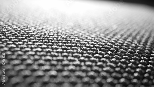 Macro lens reveals the intricate weave of black polyester, gleaming with resilience. Each fiber tightly interlocked, promising enduring strength against the test of time. 