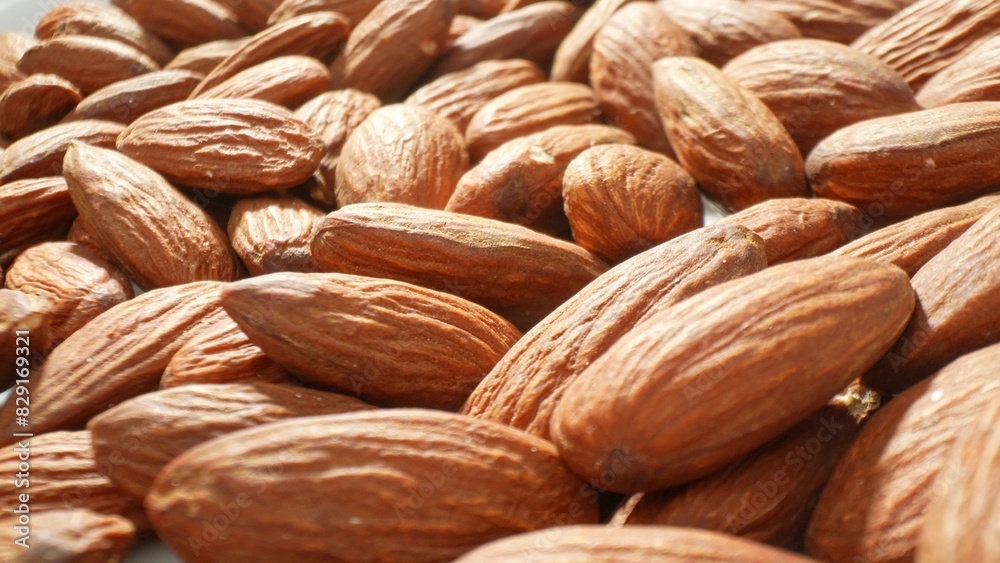 Fototapeta premium Uncover the wholesome treasure of almonds, Our premium selection is rich in vital nutrients, offering a healthy snack option or enhancing your culinary creations with delightful flavor and texture. 