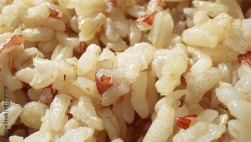 Fluffy and inviting, this close-up of cooked Jasmine brown rice reveals its tender texture and subtle grain variations. Ready to serve, it promises a wholesome and satisfying meal. 