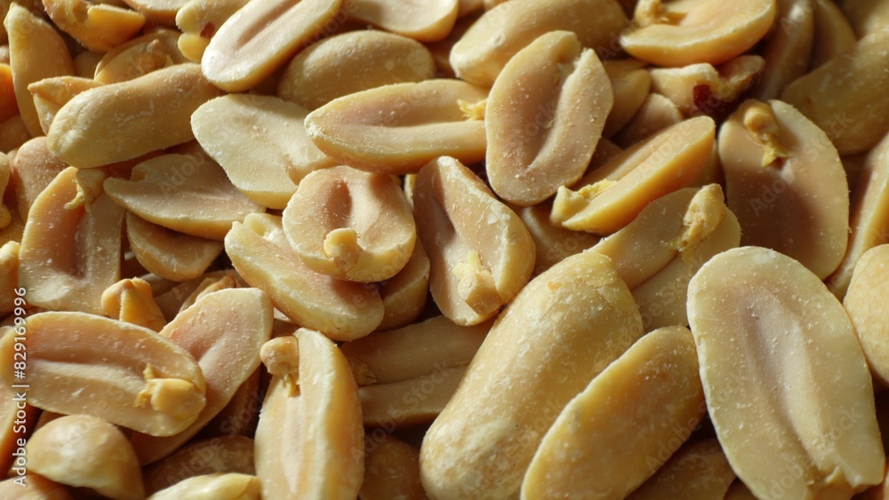 Roasted peanuts, with their split halves and lightly salted surfaces, boast a spectrum of hues from pale tan to rich brown, accentuating their crunchy texture and rich flavor.
Roasted peanuts, with their split halves and lightly salted surfaces, boast a spectrum of hues from pale tan to rich brown, accentuating their crunchy texture and rich flavor.