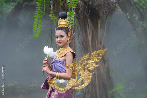 Cute girl in Kinnaree dress. The Kinnaree is significant character in Thai literature, a half-human, half-bird creature, a beautiful woman with wings to fly, resides in the Himavanta forest