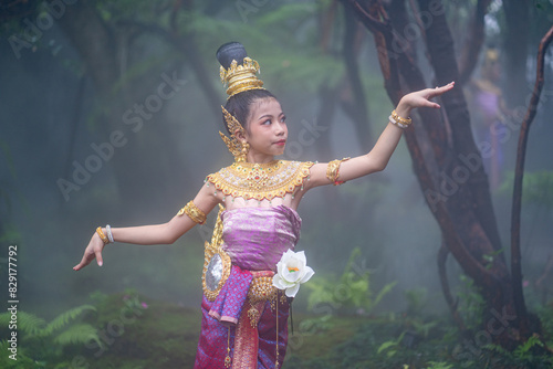 Cute girl in Kinnaree dress. The Kinnaree is significant character in Thai literature, a half-human, half-bird creature, a beautiful woman with wings to fly, resides in the Himavanta forest