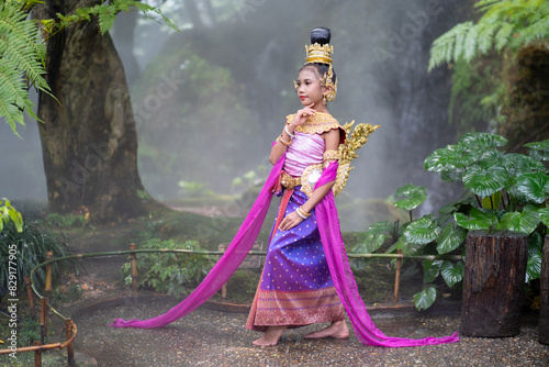 Cute girl in Kinnaree dress. The Kinnaree is significant character in Thai literature, a half-human, half-bird creature, a beautiful woman with wings to fly, resides in the Himavanta forest photo