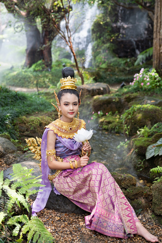 Cute girl in Kinnaree dress. The Kinnaree is significant character in Thai literature, a half-human, half-bird creature, a beautiful woman with wings to fly, resides in the Himavanta forest