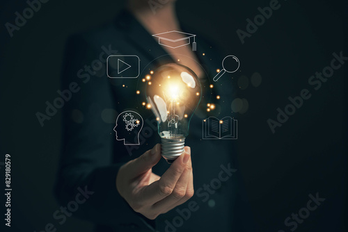 Glowing light bulb in hand, idea search concept Creativity from information trade in the internet world,education , business ideas and target groups.