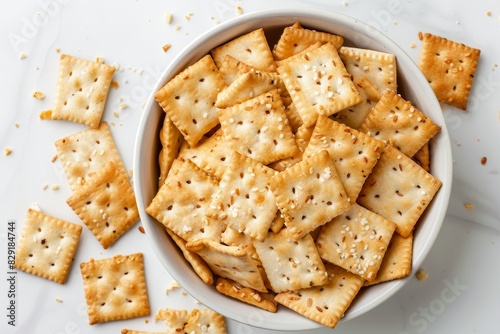 Crackers in dish on white background Top view