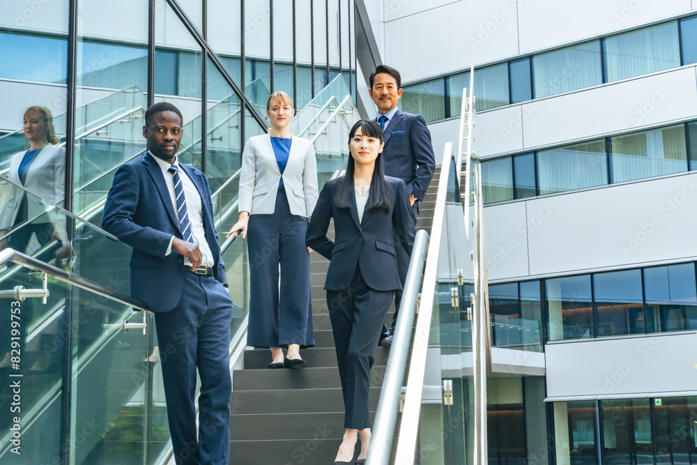 A group of multinational business people standing in front of an office building A group of multinational business people standing in front of an office building