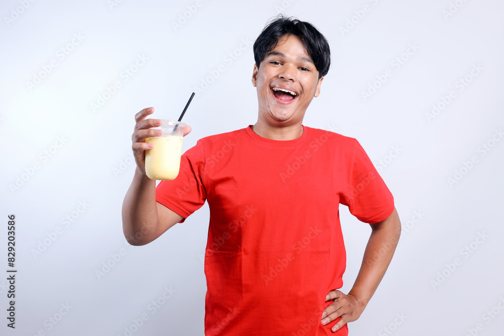 Potrait Of Happy Young Asian Man Holding Juice Drink Isolated On White Background Potrait Of Happy Young Asian Man Holding Juice Drink Isolated On White Background