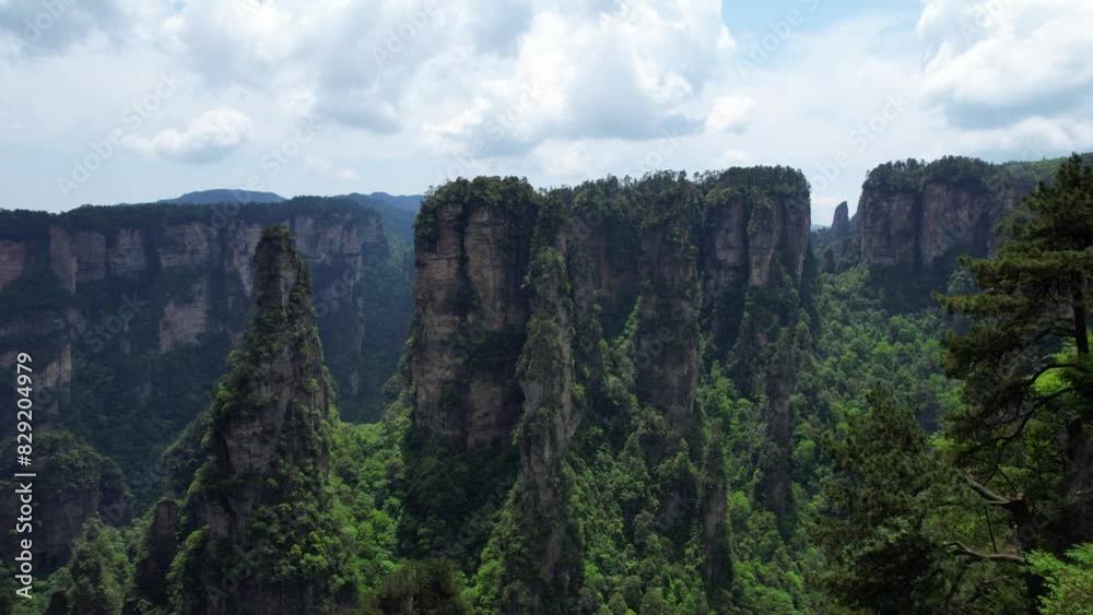 Drone flying towards towering Hallelujah Mountain in lush Zhangjiajie National Forest Park, China Drone flying towards towering Hallelujah Mountain in lush Zhangjiajie National Forest Park, China