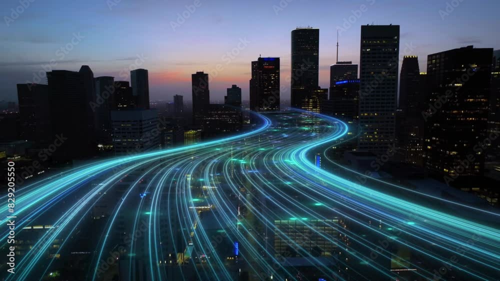 American city at dusk with curving light trails, glowing blue digital connectivity lines animation. Aerial dolly forward towards dark skyscrapers at night.
