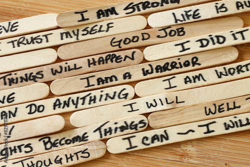 Картината върху платно Positive Affirmations Written On Wooden Popsicle Sticks With Wood Background