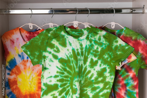 Colorful Tie-Dye T-Shirts Hanging in Closet